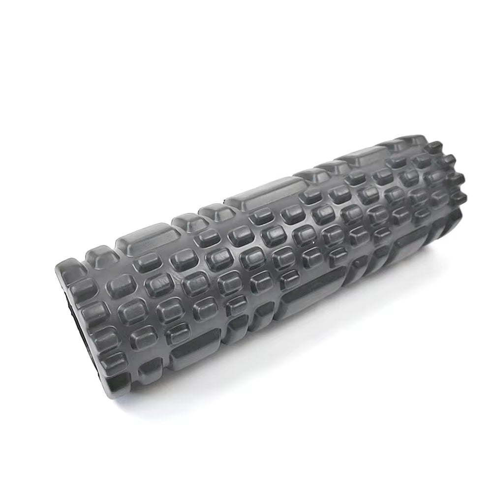 Yoga practitioner using a foam roller to enhance flexibility and muscle recovery in a serene studio setting