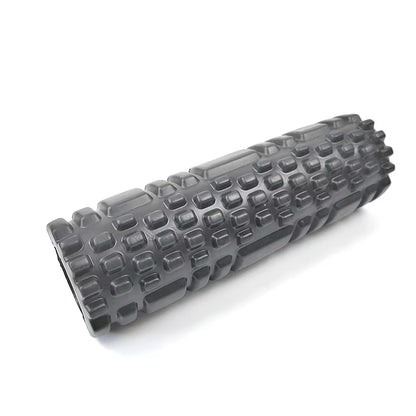 Yoga practitioner using a foam roller to enhance flexibility and muscle recovery in a serene studio setting