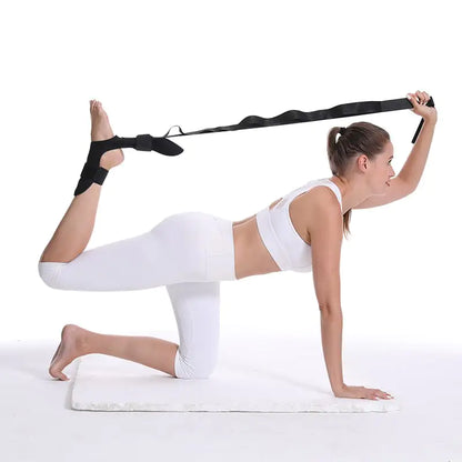 Yoga practitioner using a stretch strap for enhanced flexibility and deep muscle stretching during practice.