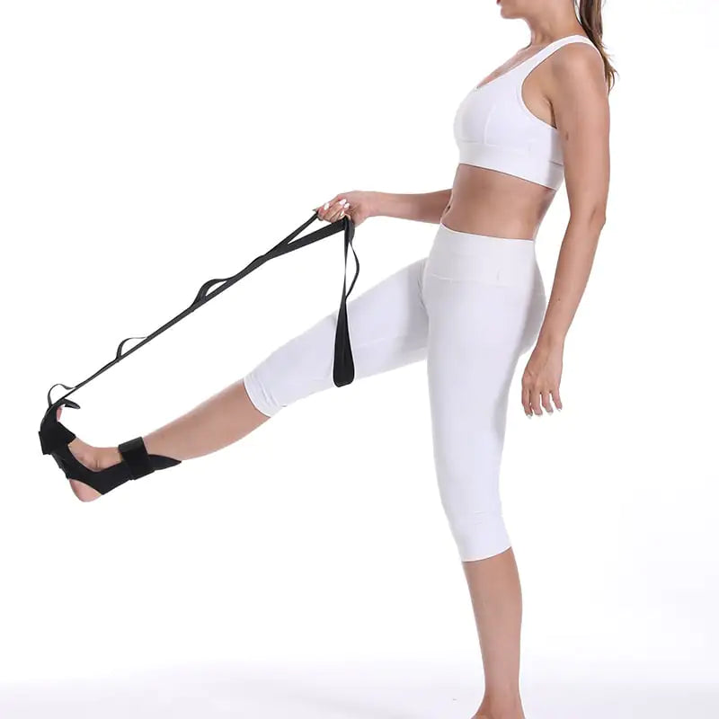 Yoga practitioner using a stretch strap for enhanced flexibility and deep muscle stretching during practice.
