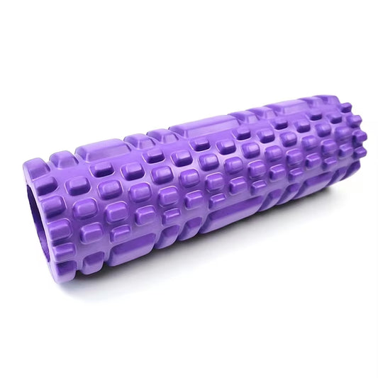 Yoga practitioner using a foam roller to enhance flexibility and muscle recovery in a serene studio setting