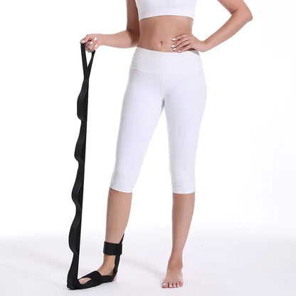Yoga practitioner using a stretch strap for enhanced flexibility and deep muscle stretching during practice.